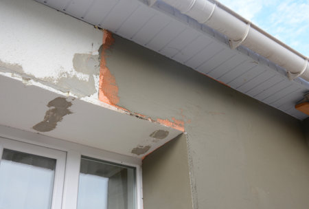 Close up on plastering exterior house wall in problem area after external wall insulation with styrofoam panels.の写真素材