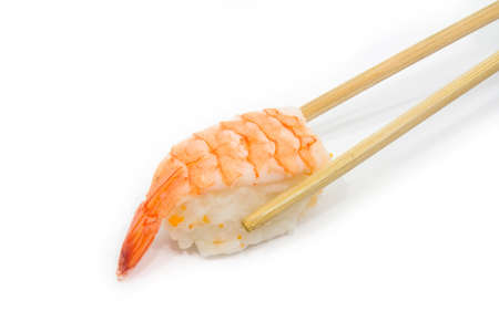Chopsticks pinning the prawn sushi on white background の写真素材