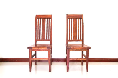 Two wooden chairs on the white wallの写真素材