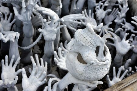 Skull and Hand from hell at Rong Khun temple,Chiang Rai northern Thailandの写真素材