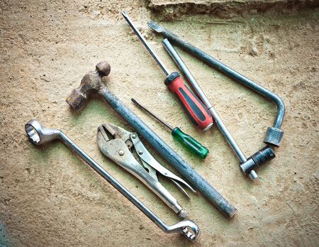 Dirty set of hand tools on floorの写真素材