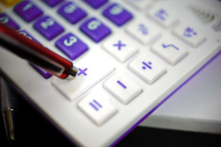 The violet calculator and red pen の写真素材