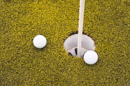 Two golf balls on golf course putting yellowの写真素材