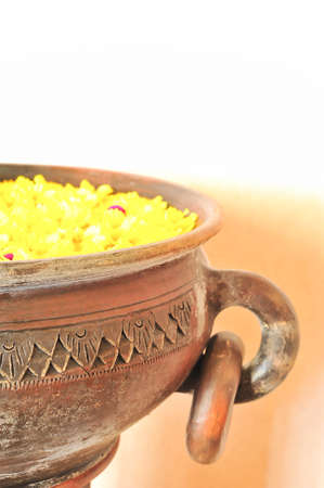 colorful of yellow flower floating in the ancient bowlの写真素材