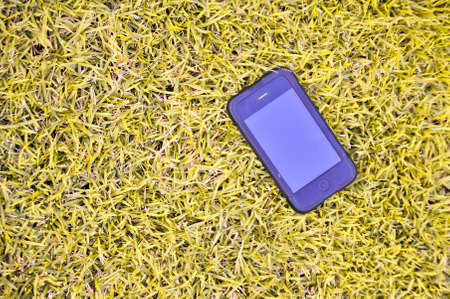 A Mobile phone on the grass