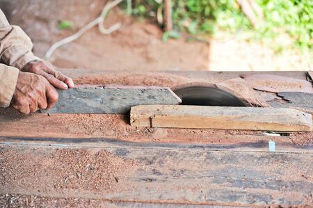 Carpenter working on woodworking machinesの写真素材