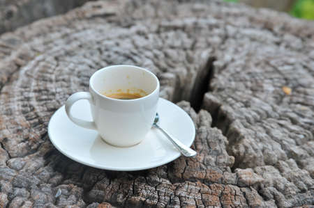 A white cup of coffee on woodenの写真素材