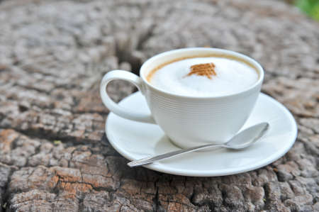 A white cup of coffee on woodenの写真素材