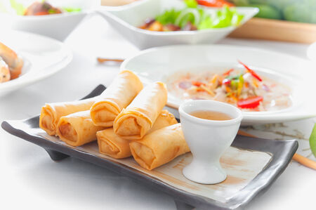 Delicious thai spring rolls with  sauce on dish