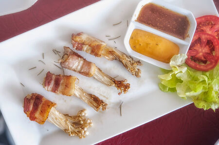 Golden mushroom wrapped in Bacon Pan-Friedの写真素材