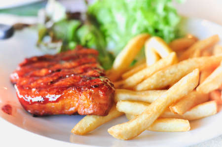Pork loin steak in a dish Serve with French friesの写真素材