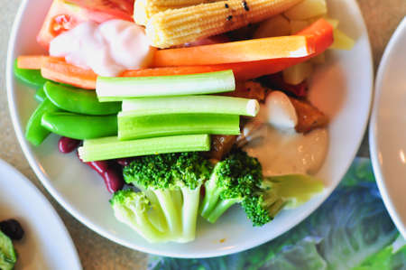 fresh vegetable salad on white disc, close-upの写真素材