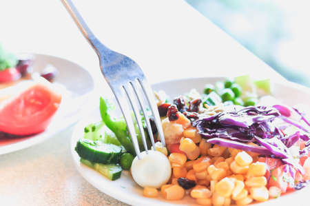 fresh vegetable salad on white disc, close-upの写真素材