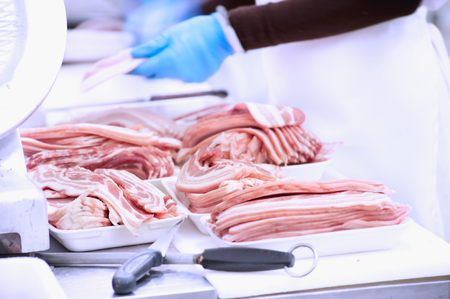 butcher packing pork in meat industryの写真素材