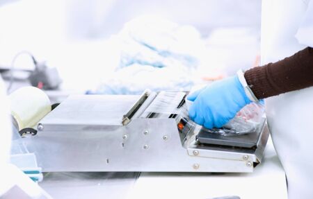 Butcher wrapping pork in meat industryの写真素材