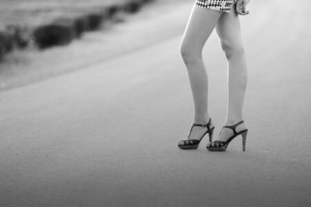 beautiful woman legs in high heel shoes on the roadの写真素材