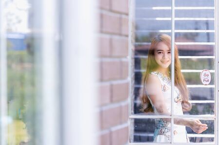 Beautiful asia young woman with opened doorの写真素材