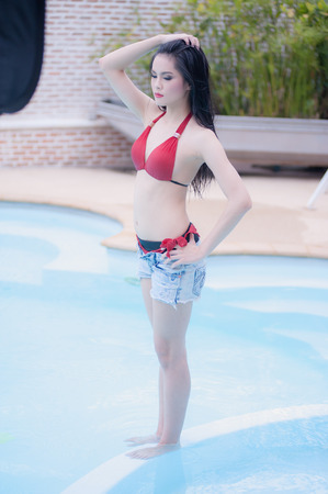 asia sexy young girl standing near swimming poolの写真素材