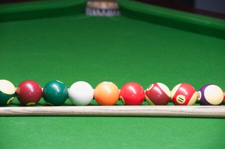 Billiard ball and cue on green tableの写真素材