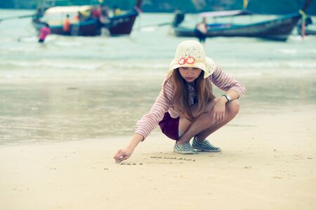 Heart on the beach hand asia woman is writingの写真素材
