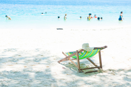 A colorful beach chair on the sandの写真素材