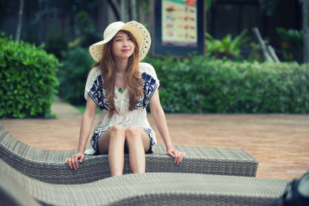 Asia beautiful relex on lounger near swimming pool in hotel, krabi, Thailandの写真素材