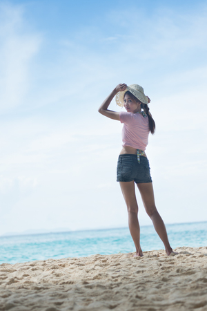 portrait of Asia young woman standing on the beachの写真素材