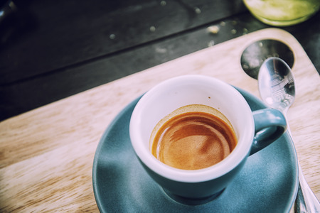 working time. hot coffee, espesso with laptop on wood teble. business conceptの写真素材