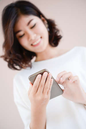 asia happy young woman with her smart phone, technology conceptの写真素材