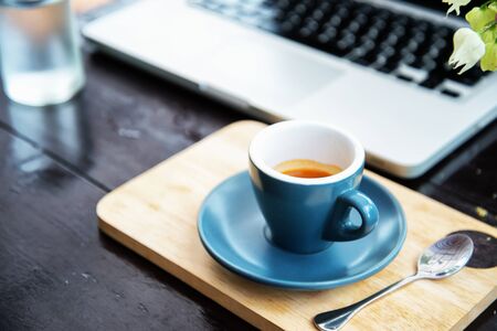 working time. hot coffee, espesso with laptop on wood teble. business concept