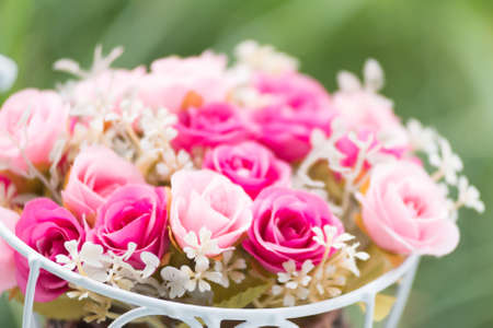 the Decoration artificial flower rose in gardenの写真素材