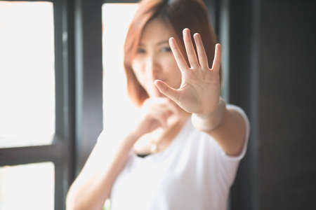 Asian women showing stop hand gesture,  focus handの写真素材