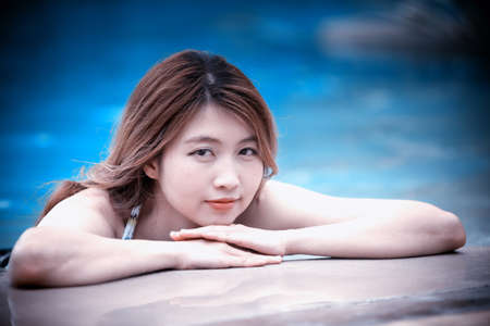 Asia beautiful Woman at the Edge of Swimming Poolの写真素材