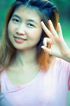 asia young cute woman showing "OK"の写真素材