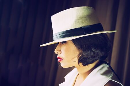 head shot of asia woman with hat in room, beauty concept, vintage effect
