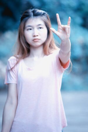 asia beautiful young woman show one hand love signの写真素材