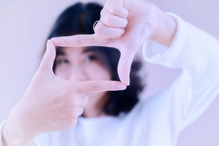 asia beutiful girl make hand symbol the frameの写真素材