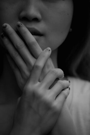 close-up of beautiful face women and manicured fingersの写真素材