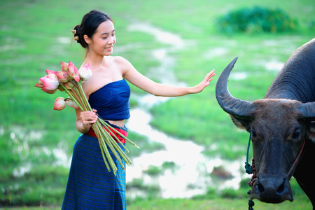thai ancient young women with buffalo on rural