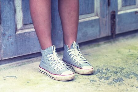 asia women in shoe standing relax against  wood wall, vintage effectの写真素材