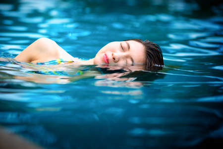 Young woman in the swimming pool