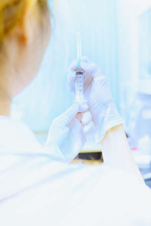 asia young doctor woman with syringe in hospital