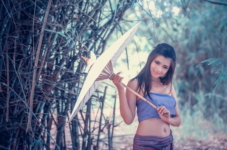ancient Thai Woman In Traditional Costume Of Thailand with vintage umbrellaの写真素材