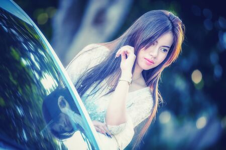 fasion of asia Young girl in dress with luxury motor car, vintage effectの写真素材