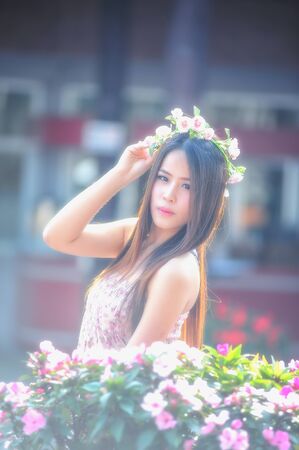 portrait of asia young women standing at colorful flowerの写真素材