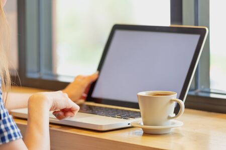 asia beautiful using her laptop and drinking cup of coffee in cafe, Vacations concept.