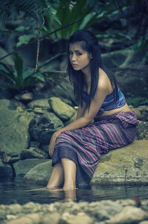 vintage Thai Woman In Traditional dress Of Thailand on shore of lakeの写真素材
