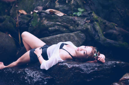 asia sexy woman sit in rockの写真素材