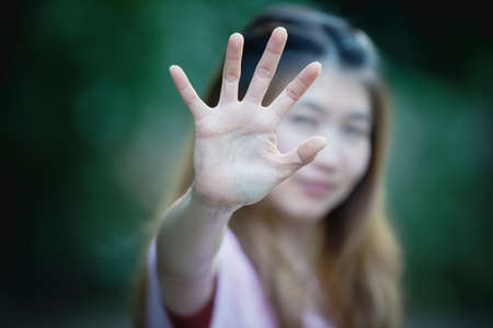 Asian women showing stop hand gesture,  focus handの写真素材
