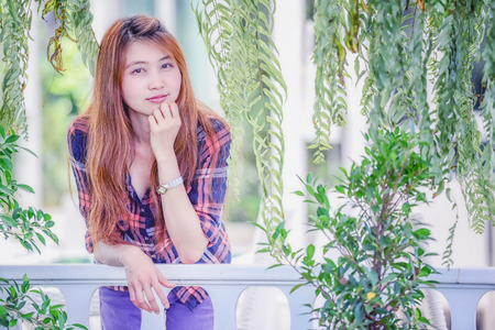 portrait of Asia young Woman in park and looking at camera